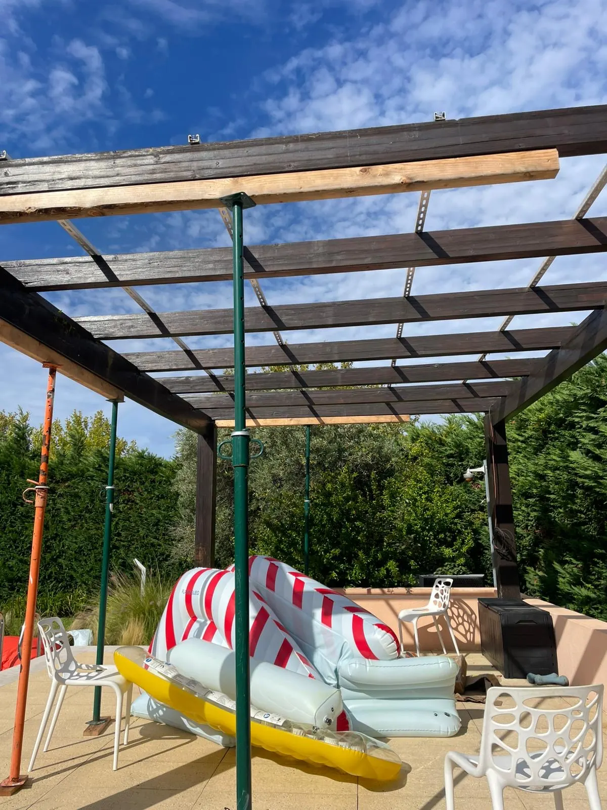 Old wooden pergola held up by metal props