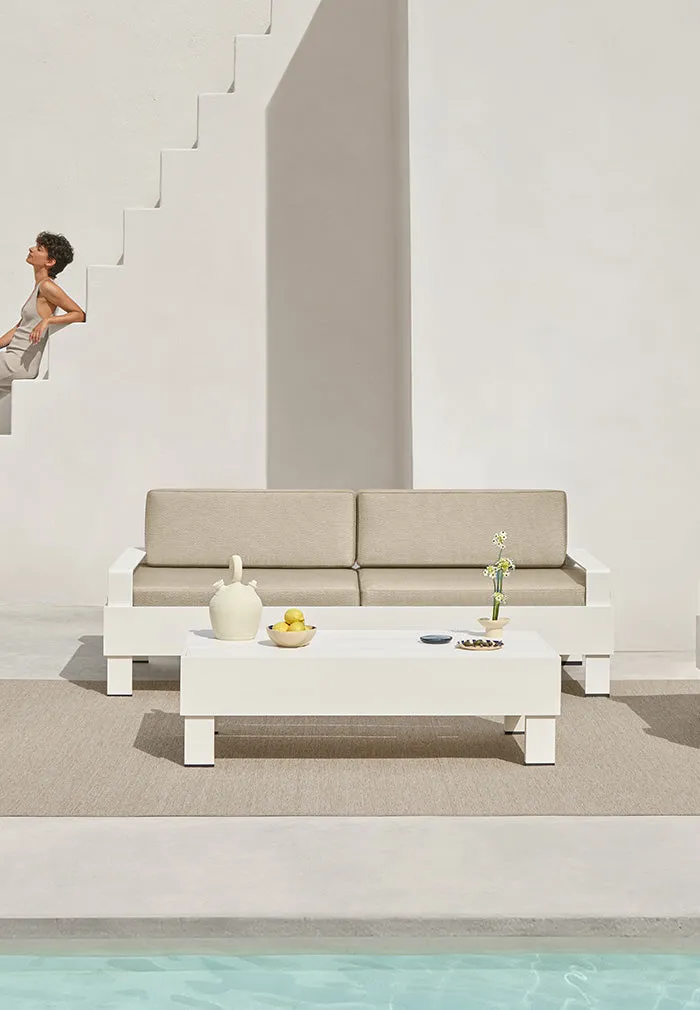 White Zenttal table and sofa on a terrace by the pool